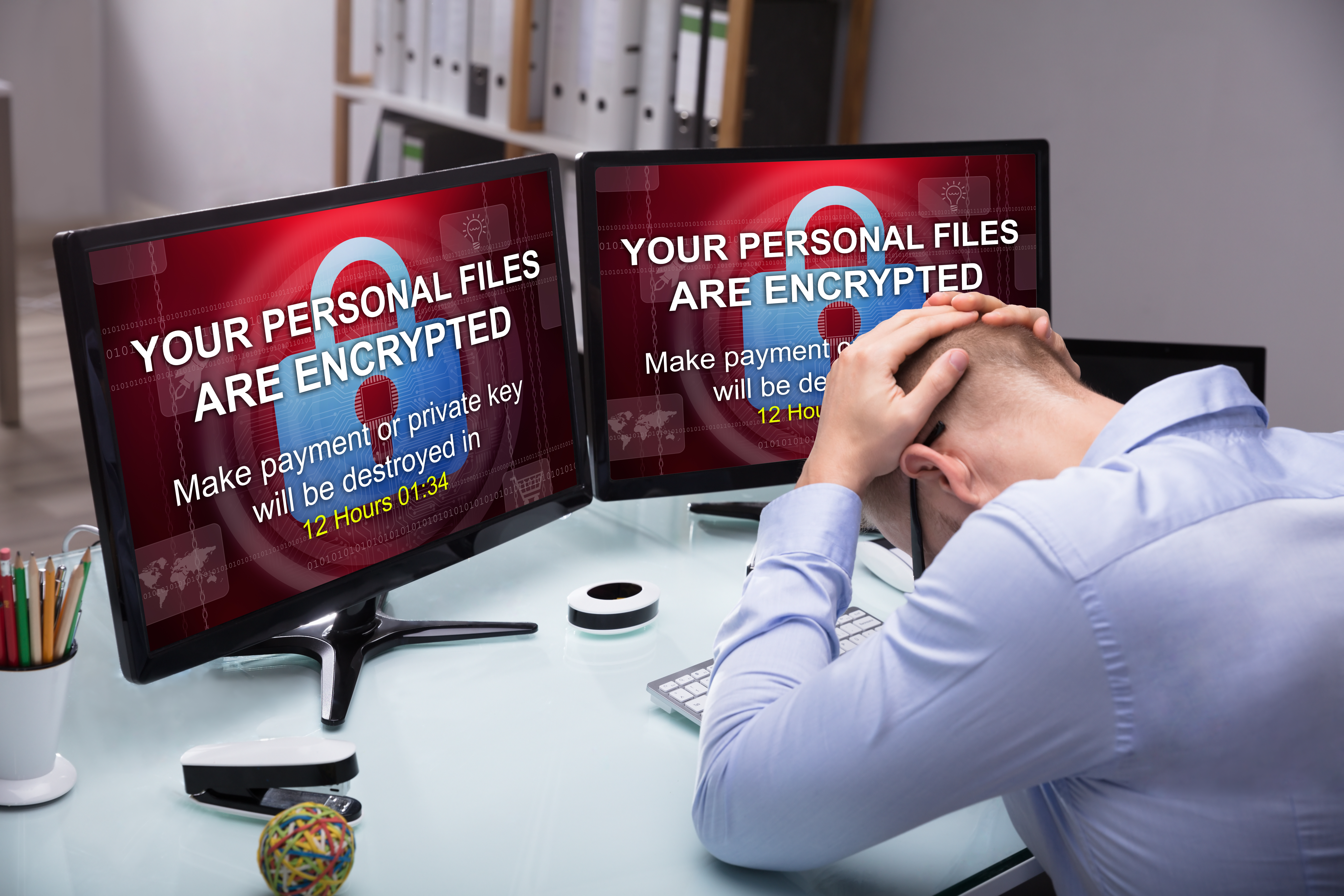 Man at his desk with encryption message on screen